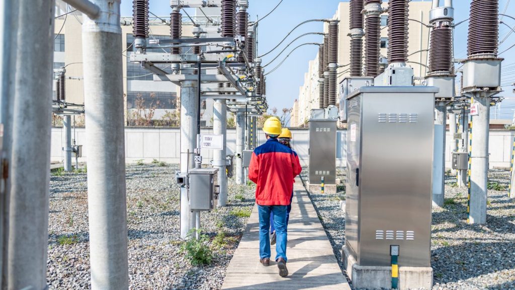 Two employees walking around aligned data center campus